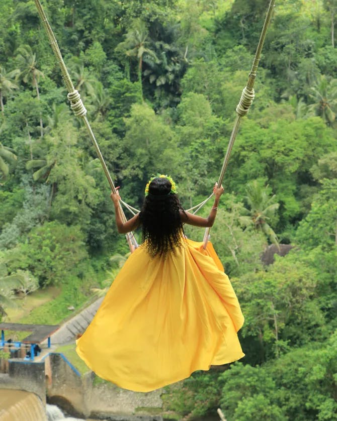Picture of Mesha in yellow dress on swing