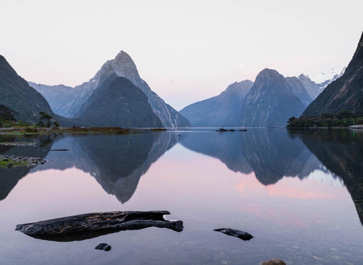 Mountains over lake with reflection during dusk in New Zealand.