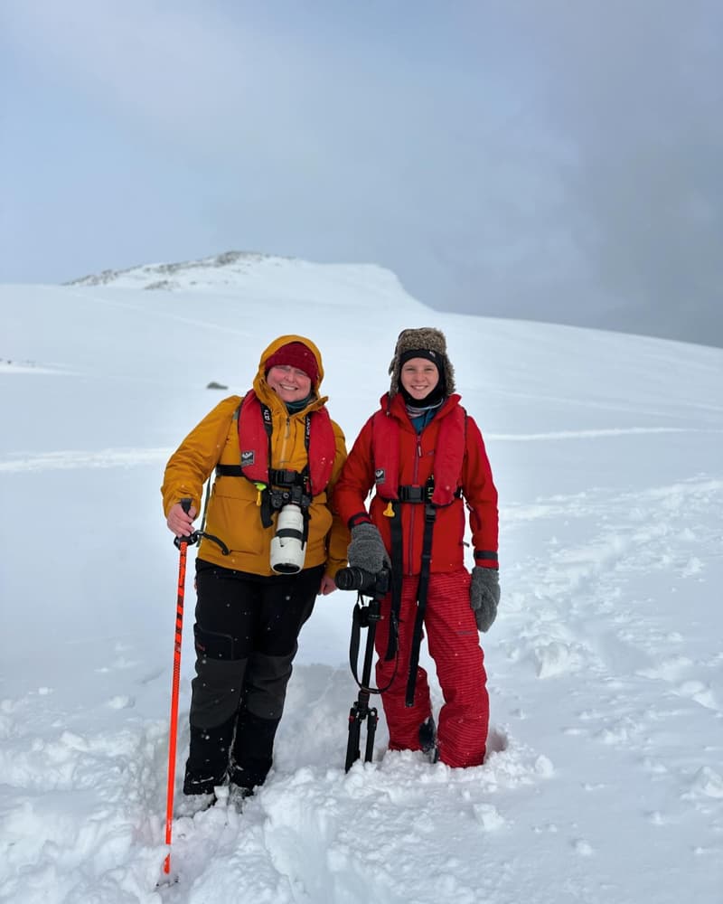Karilyn and her son taking a break from hiking in the snow.