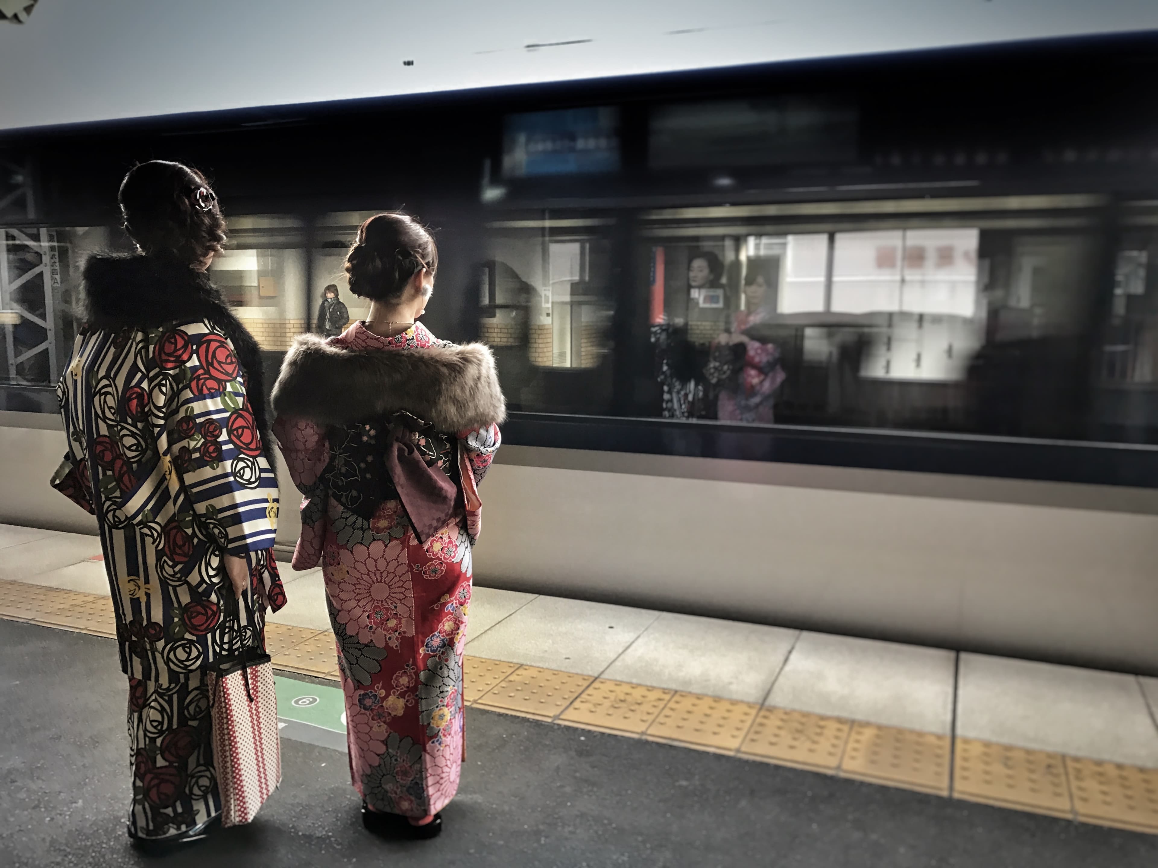 Picture of two women standing on train station