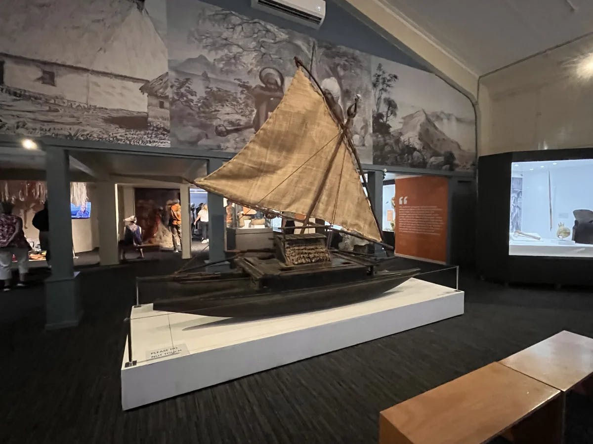 A large model of a fishing boat inside a museum