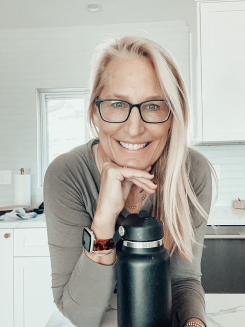 woman wearing black glasses and a grey shirt