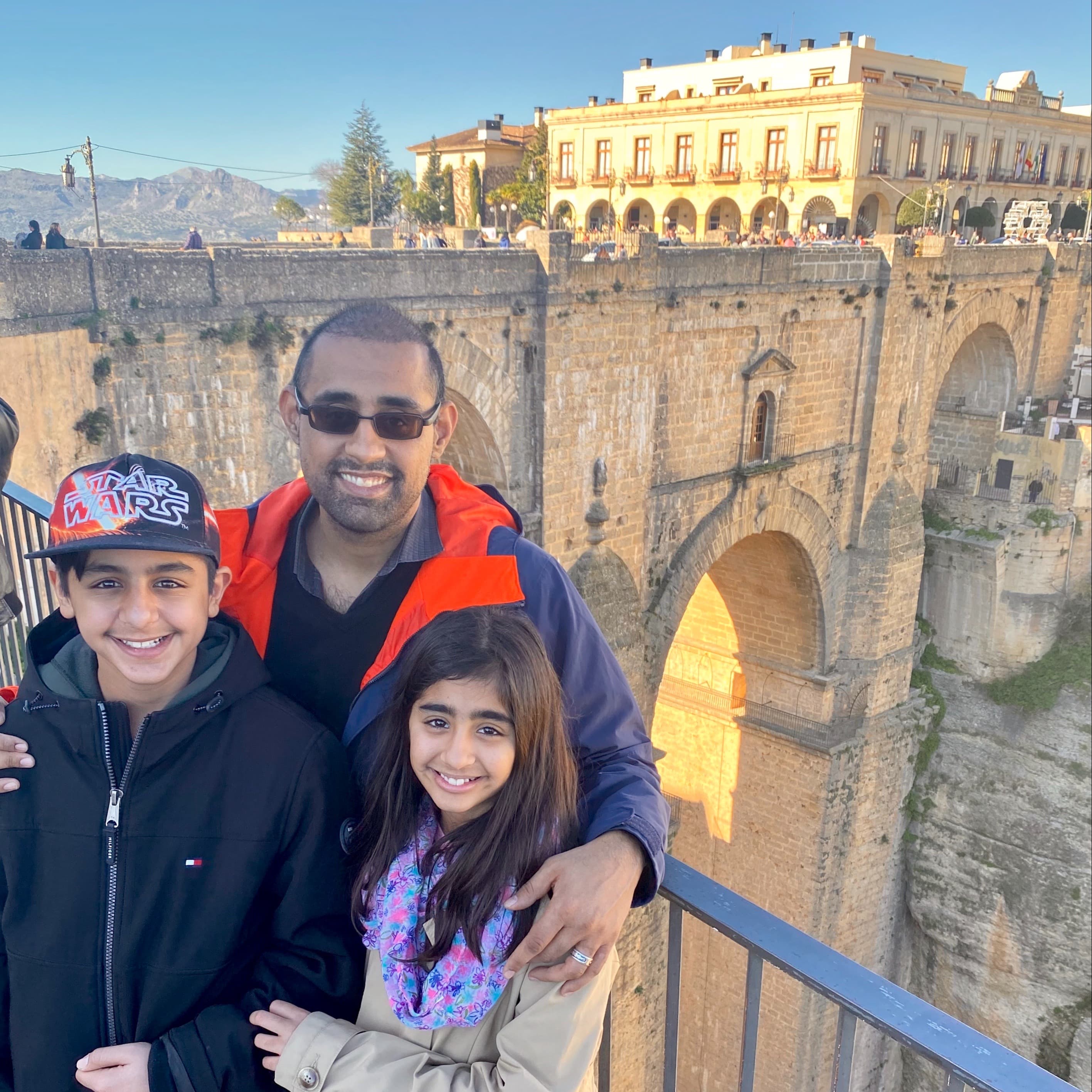 A man and two kids posing for a photo.
