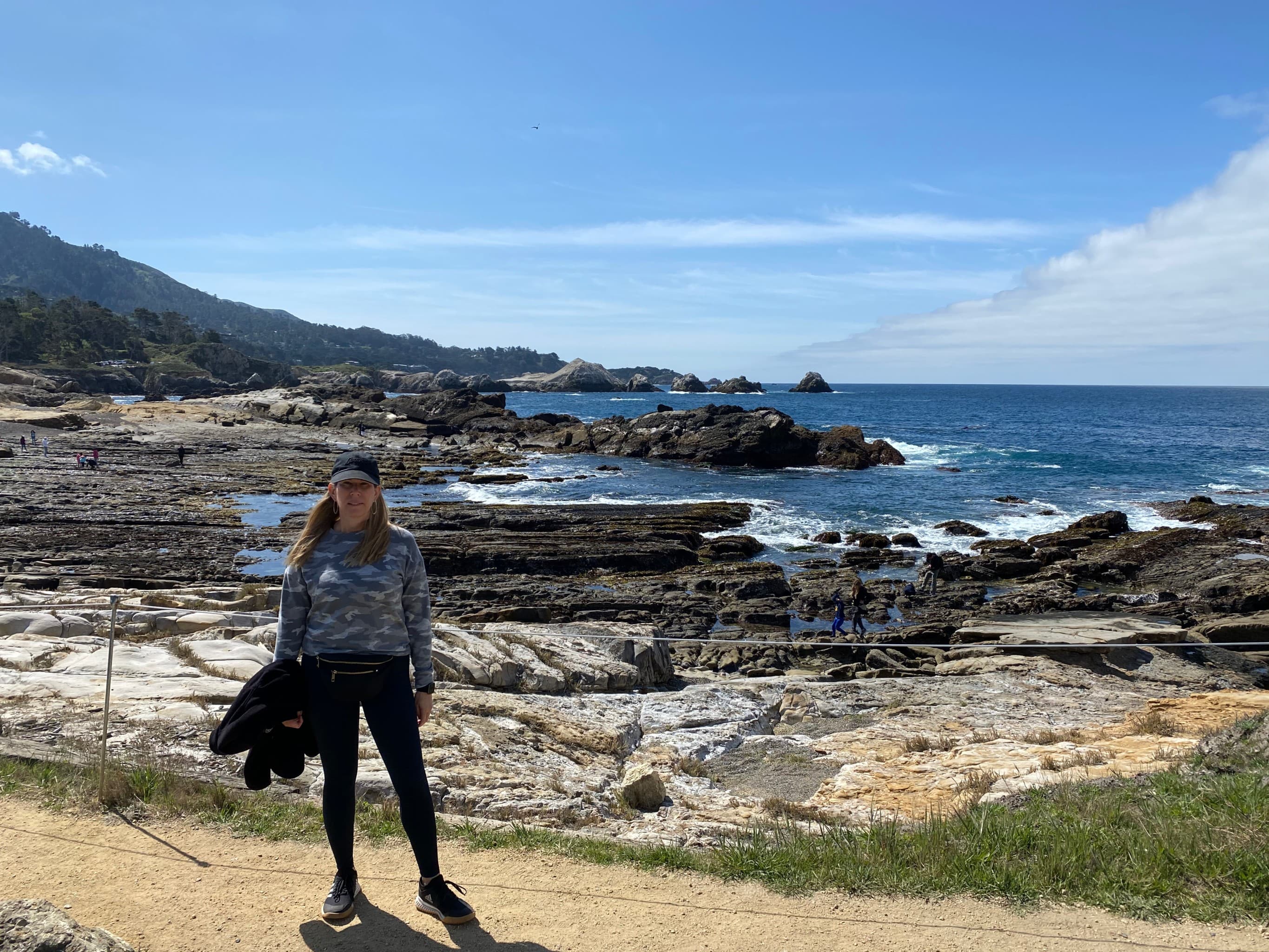 Girl on rugged coastline.