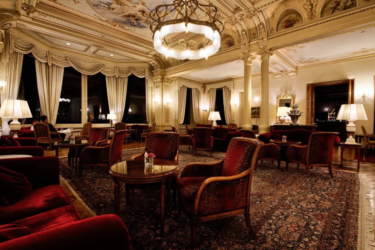 The lobby of Grand Hotel Kronenhof in Switzerland, with traditional Old World decor and an overall ritzy vibe