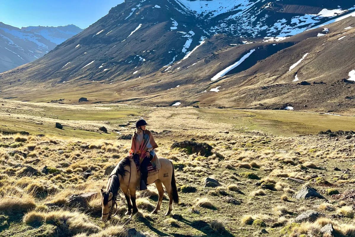 A person on horseback in a valley 