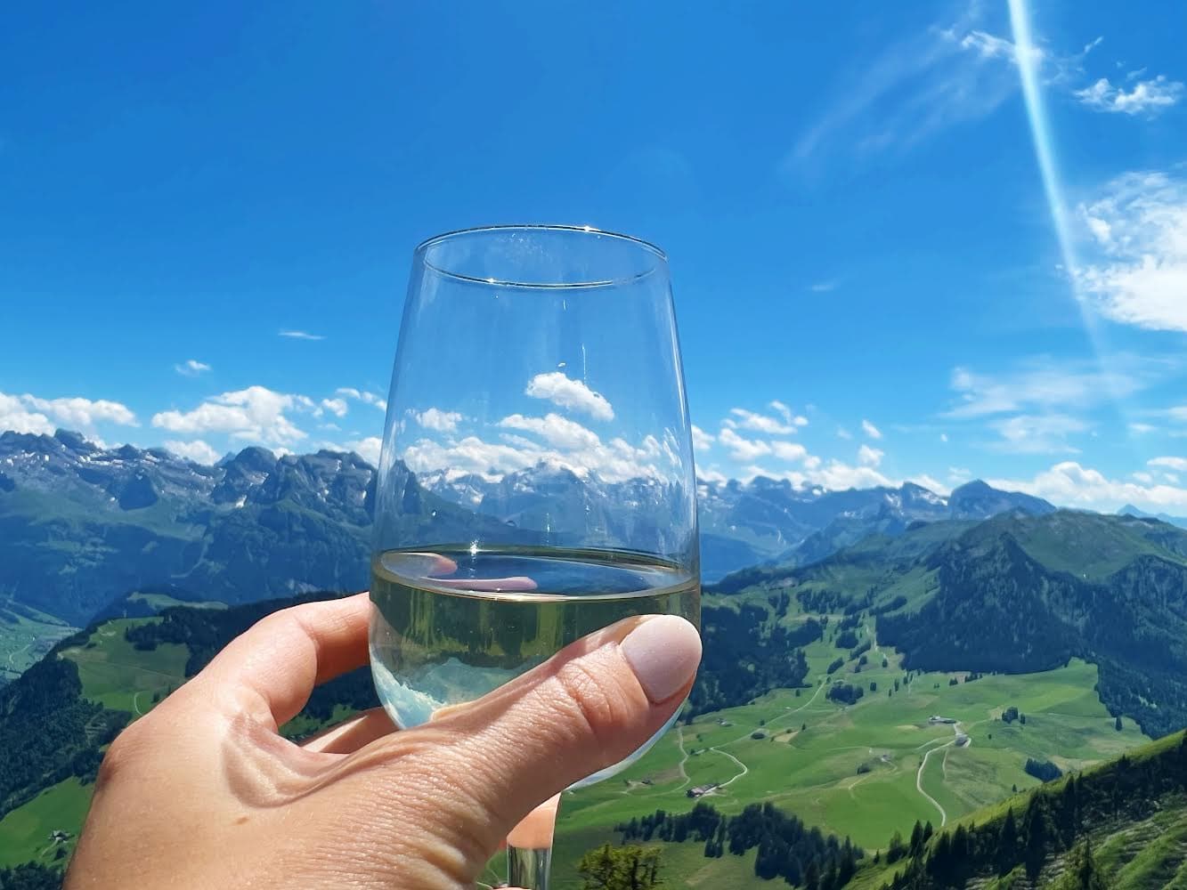Image of a glass of drink and mountains