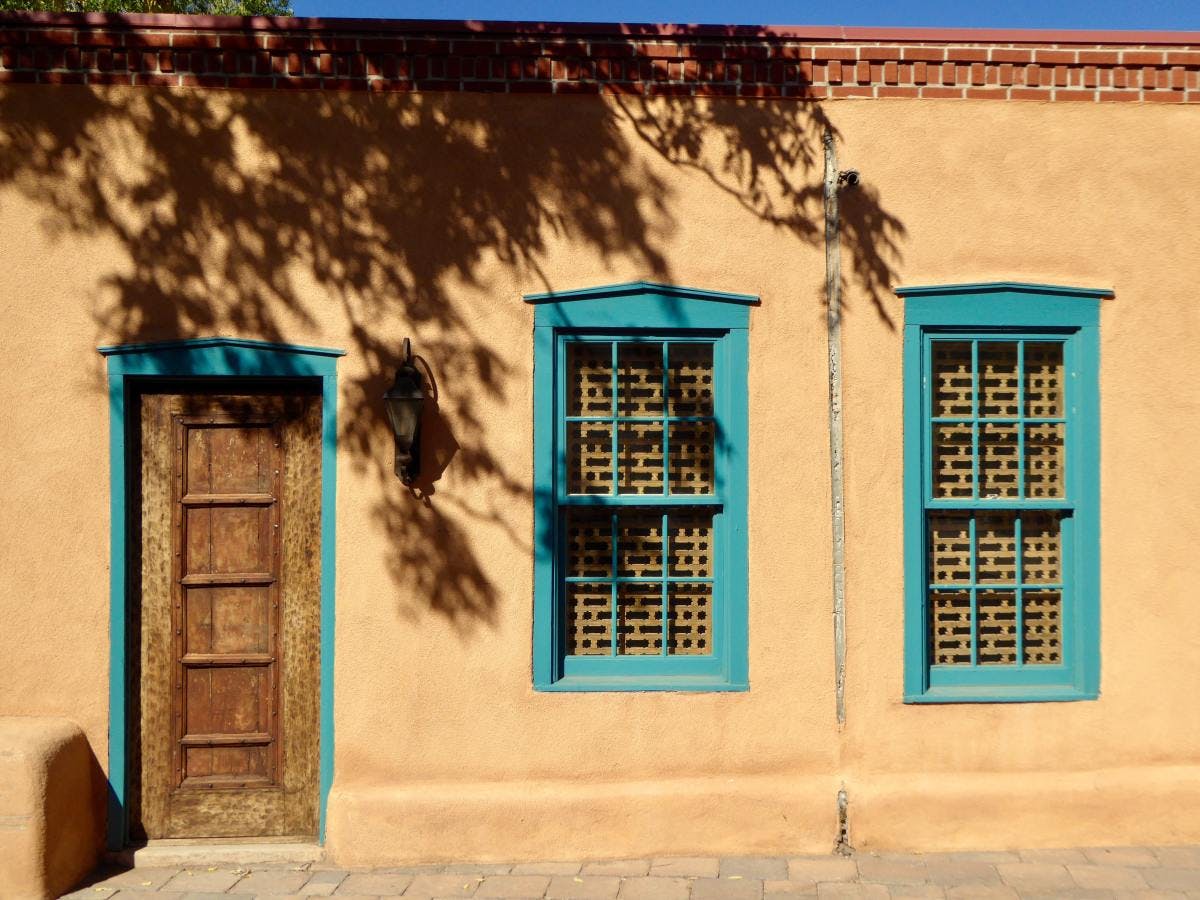Pueblo building with turquoise border on windows and doors in Santa Fe.