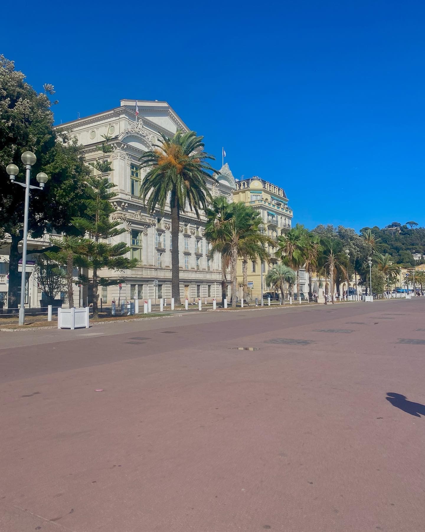 A road with white building.