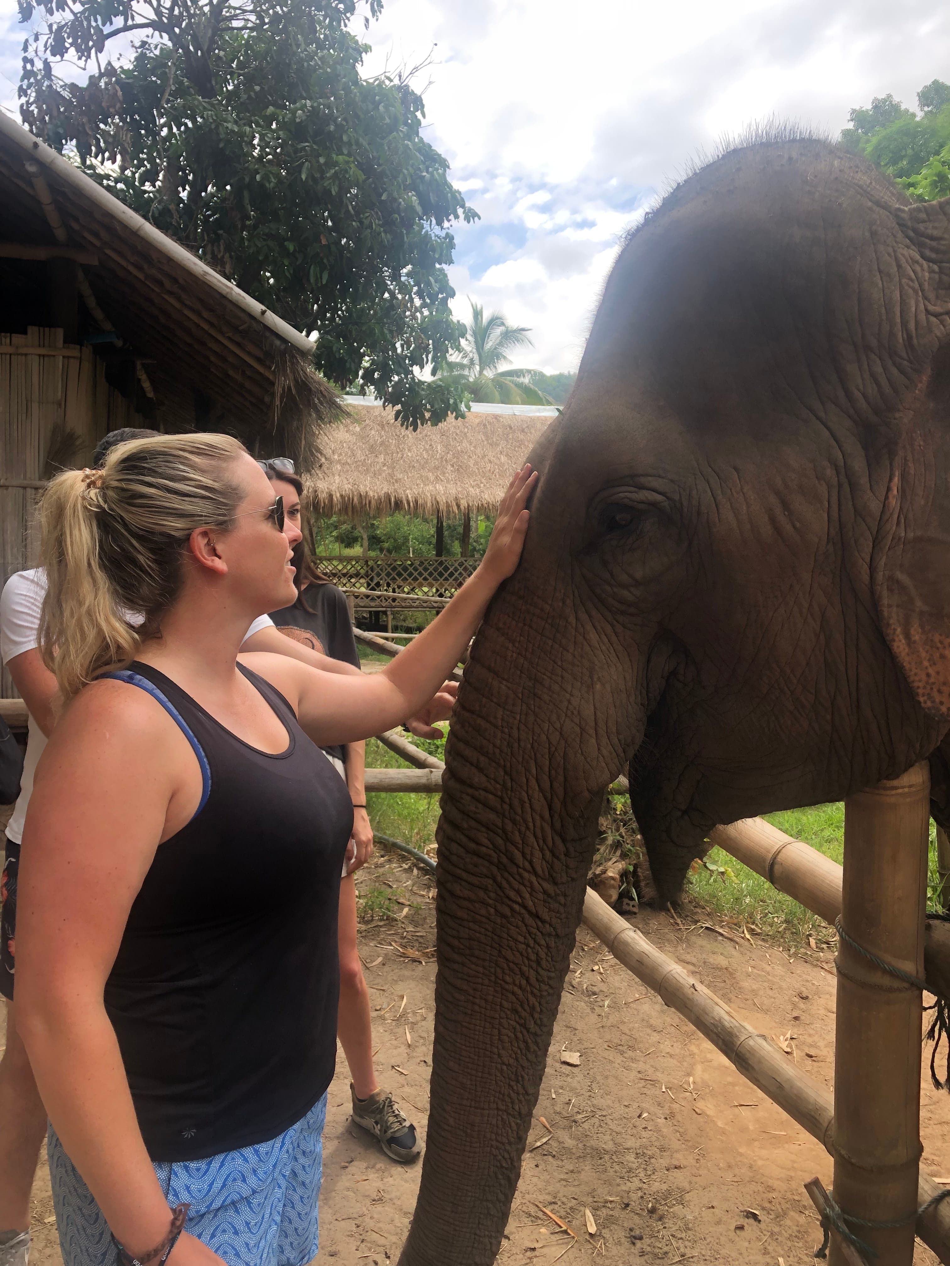 Travel advisor posing with an elephant