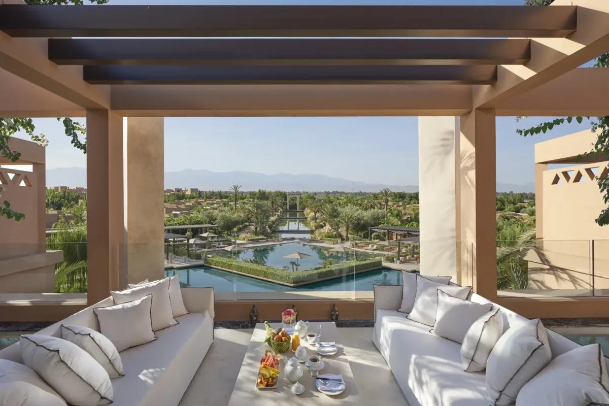 A private meal is set up for unseen travelers on a rooftop terrace belonging to one of the property's riad-style villas