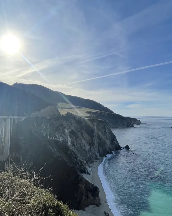 The Bixby Creek Bridge next to a view of the sea on a sunny day