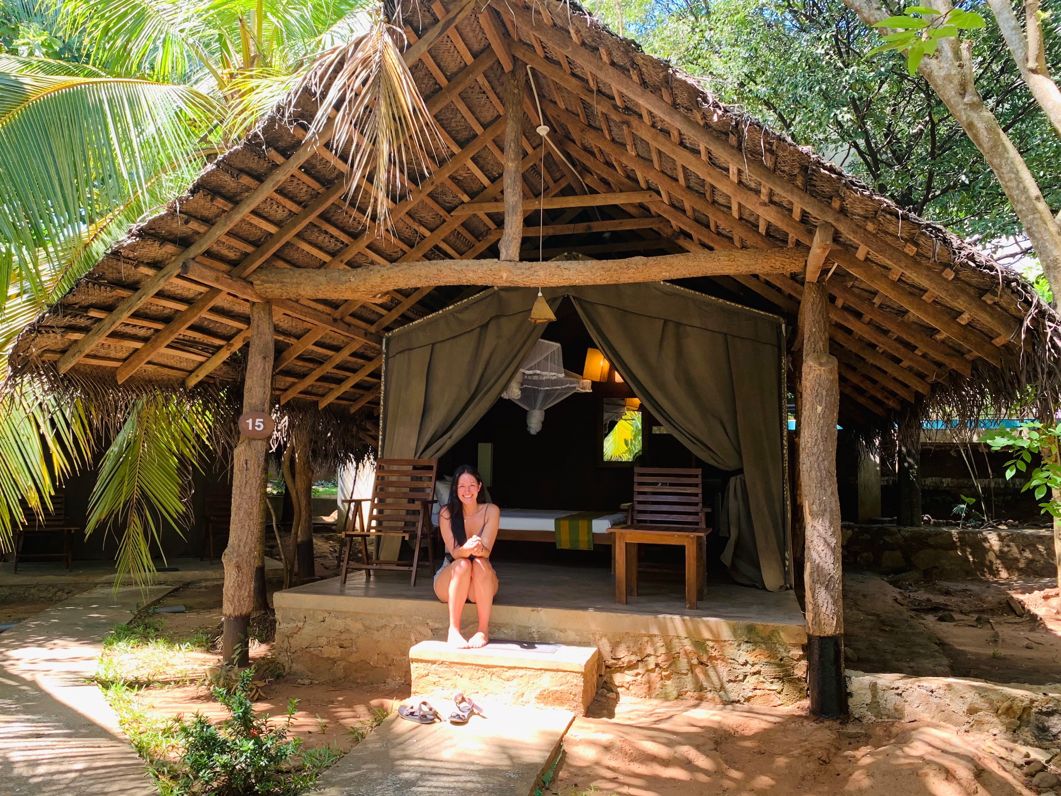 Travel advisor posing in a hut