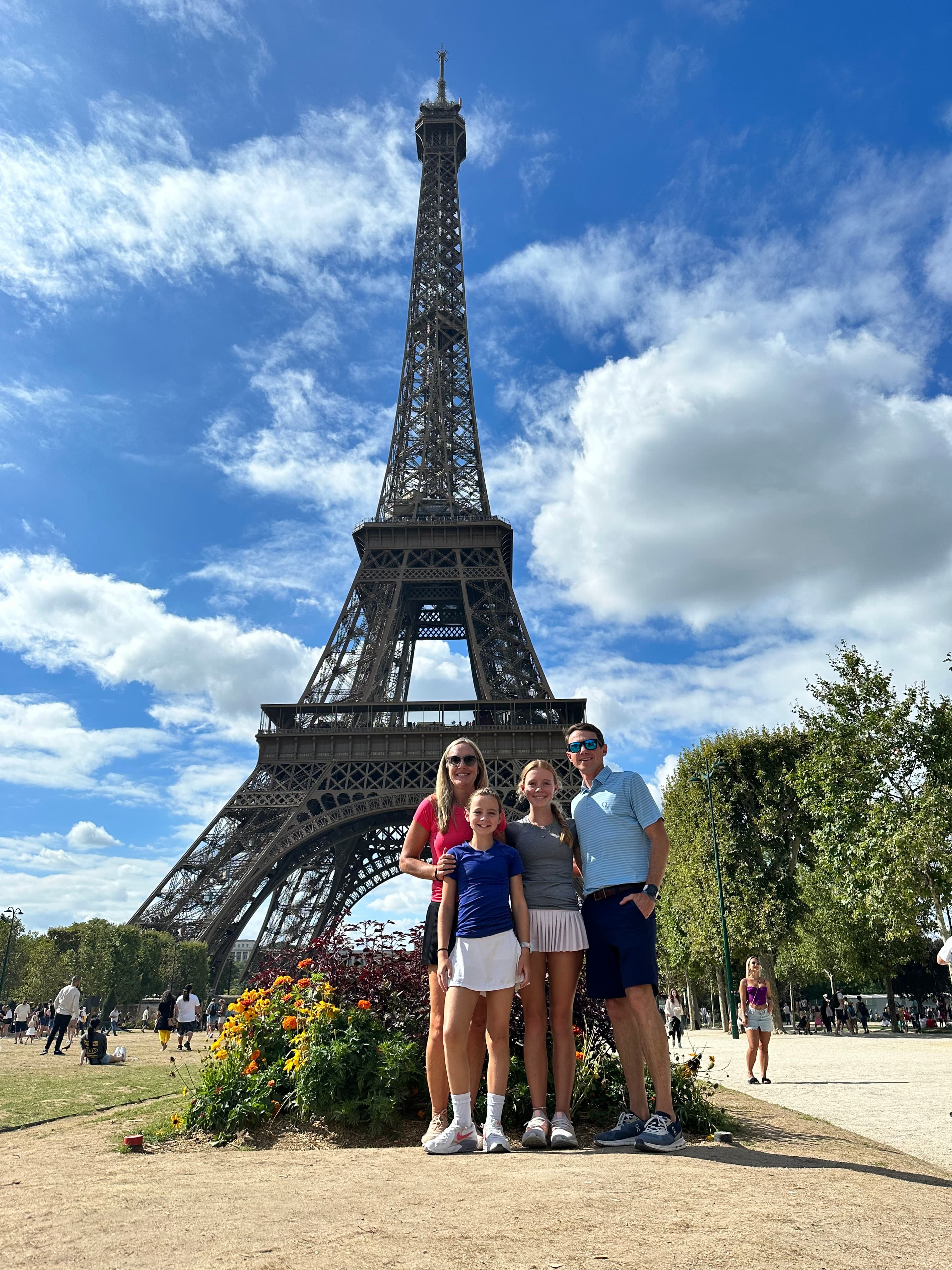 Posing for a family photo at the Eiffel Tower