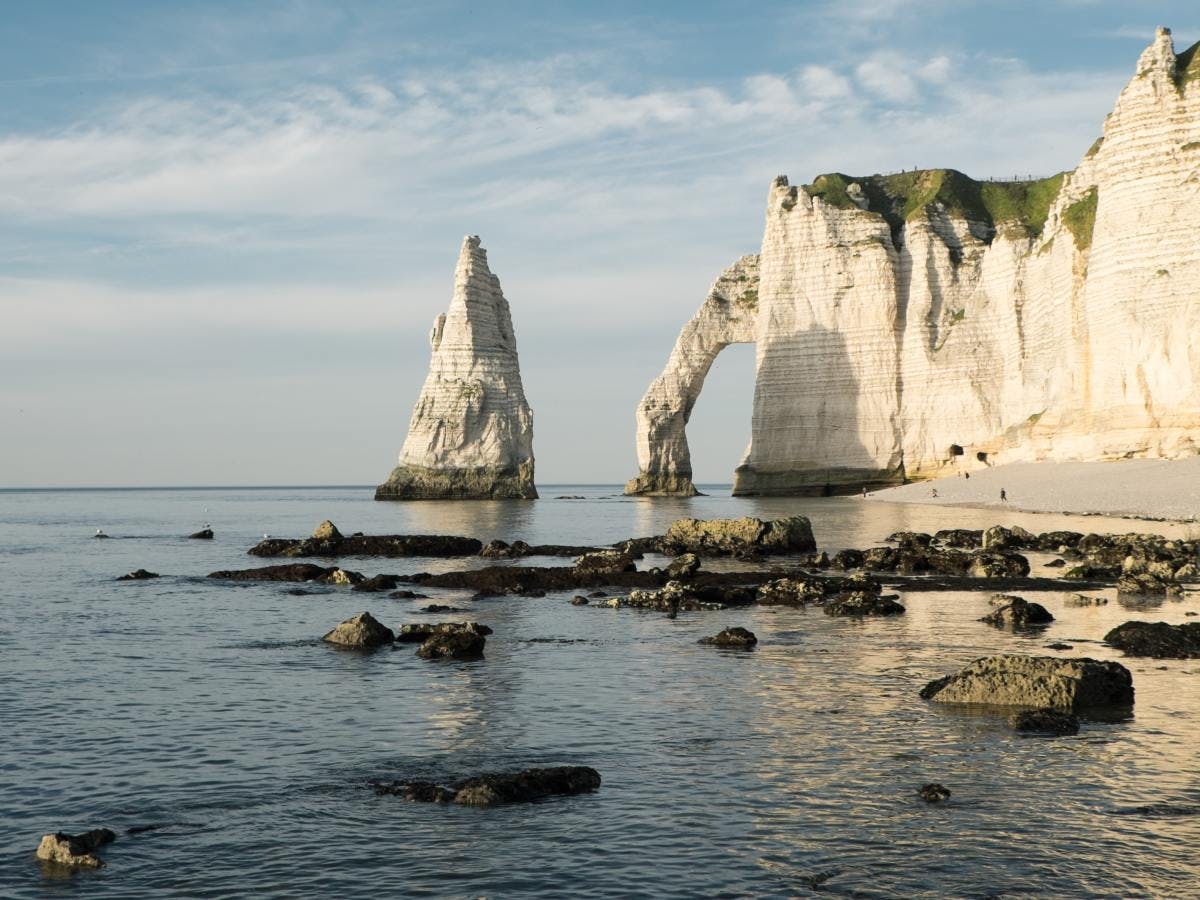 Rock formations by the ocean in Etretat in Normandy, France.