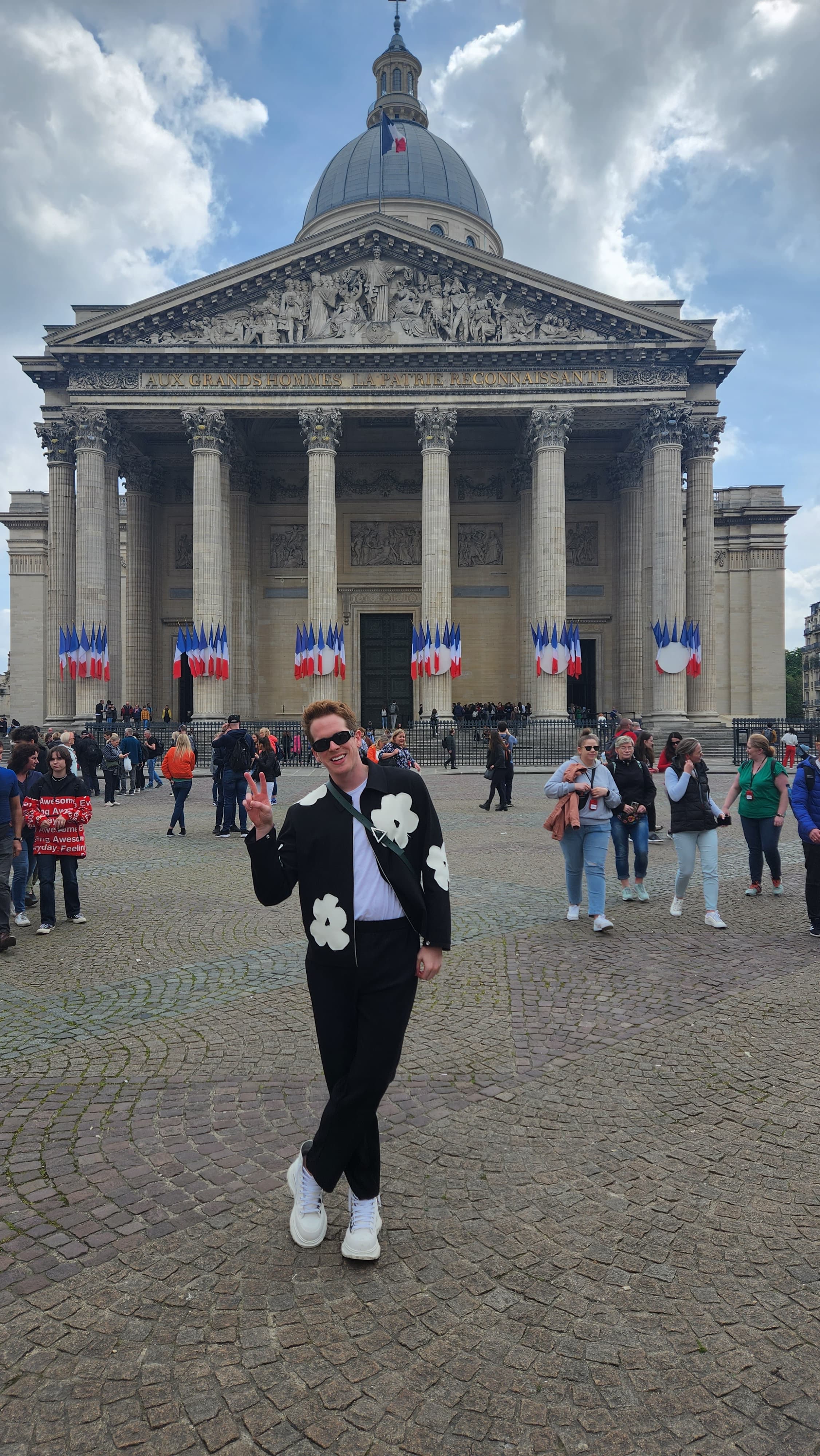 Lucas standing in front of the Panthéon on a cloudy day with tourists in the background