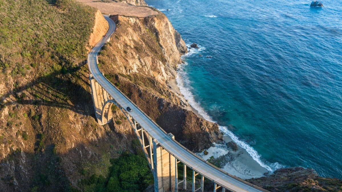 Birdview of Bixby Bridge on PCH highway overlooking the Pacific Ocean and sitting above the Big Sur's oceanside cliffs in Monterey County, CA. 