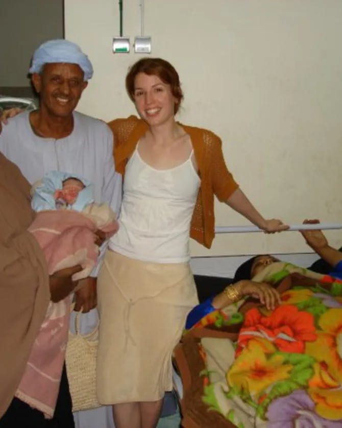 Posing with a family holding a newborn child