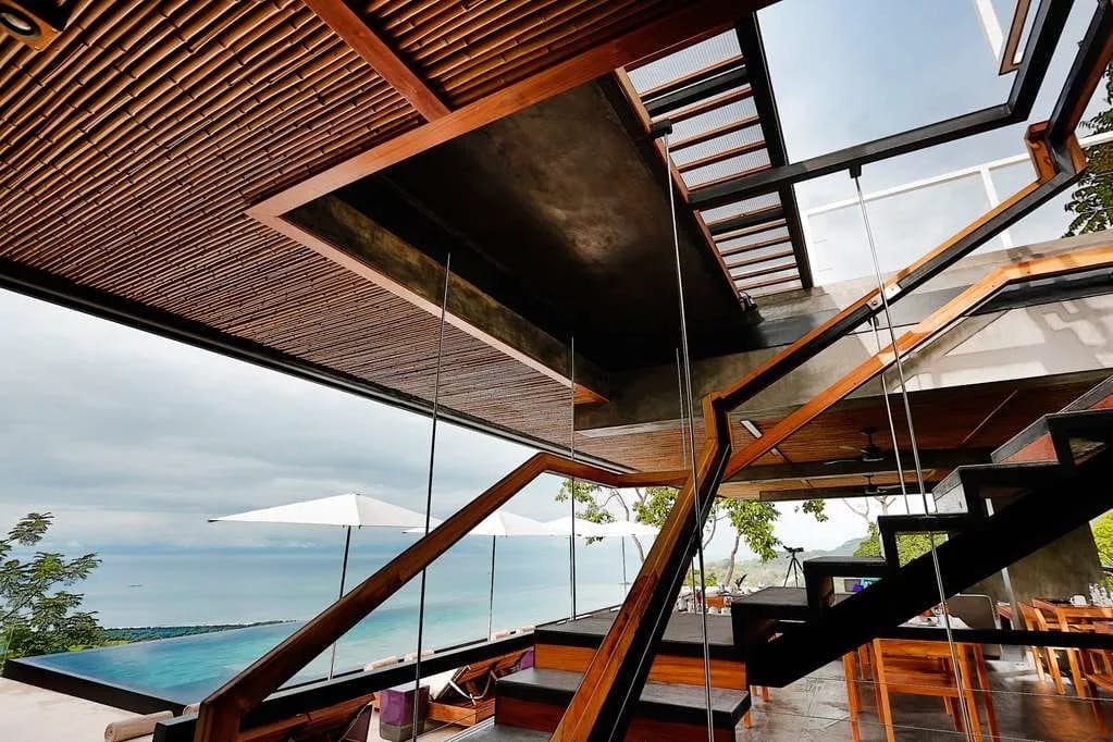Kura Boutique Hotel's contemporary architecture style is on full display on its rooftop terrace, which hosts an infinity pool and stunning views of Uvita Beach in the distance