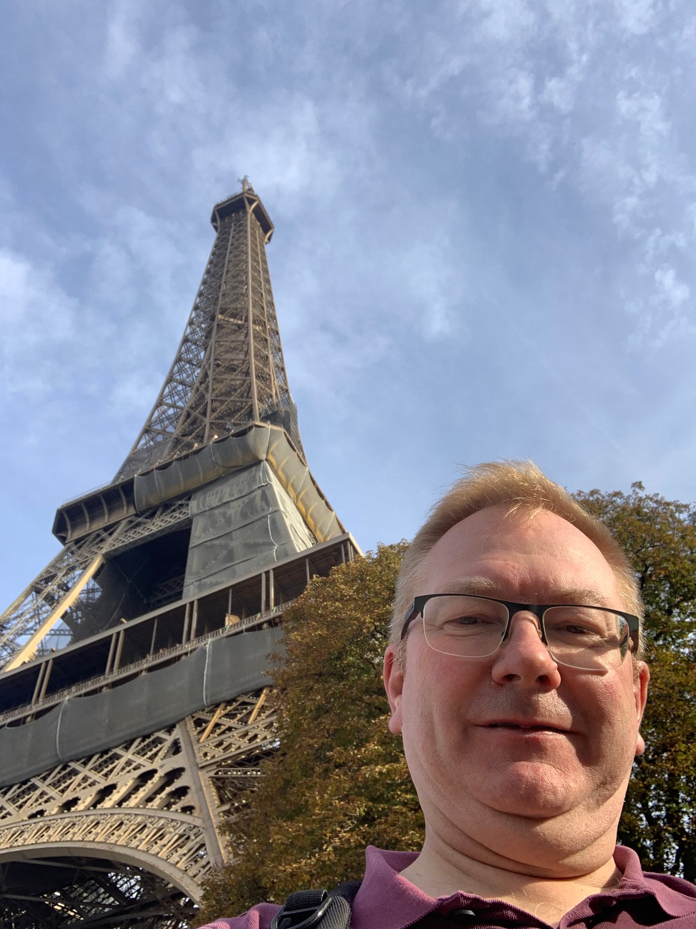 Pat taking a selfie of himself right below the Eiffel Tower.
