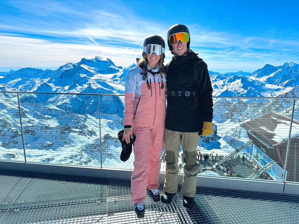 Couple standing in front of snow-covered mountains