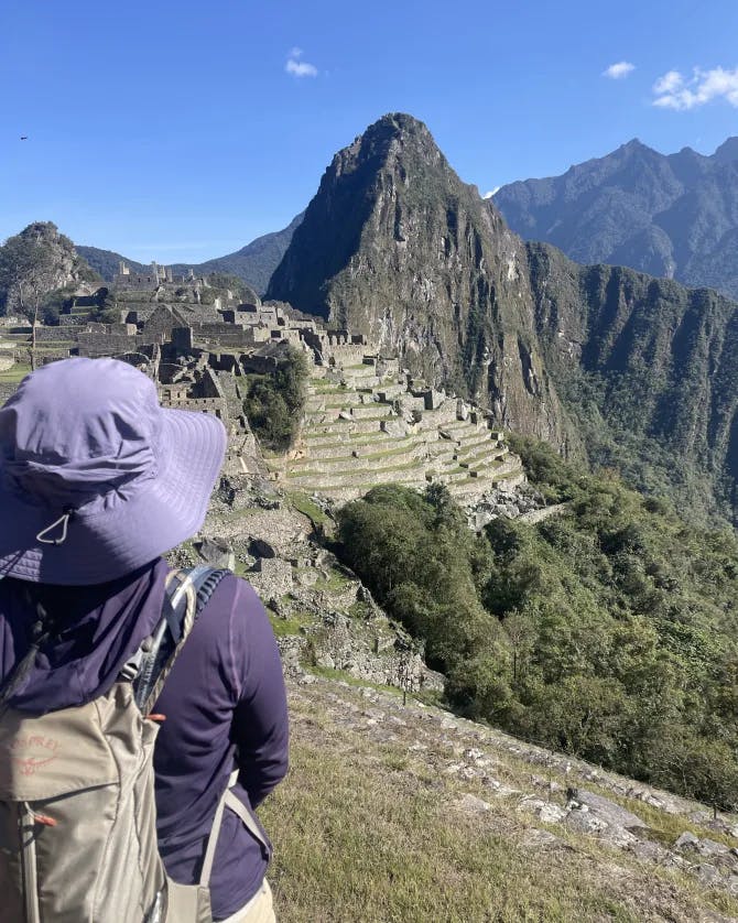 Cam wearing purple gear while hiking in Machu Picchu