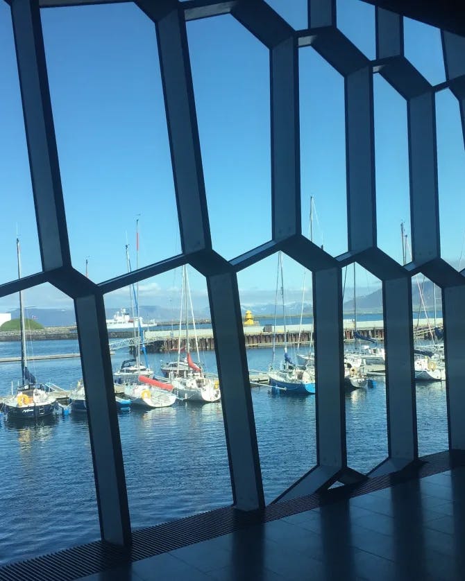 A view of boats docked in the harbor from inside of a window