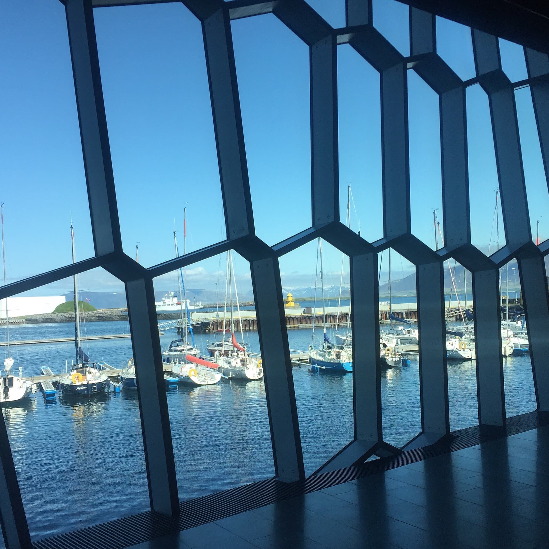 A view of boats docked in the harbor from inside of a window
