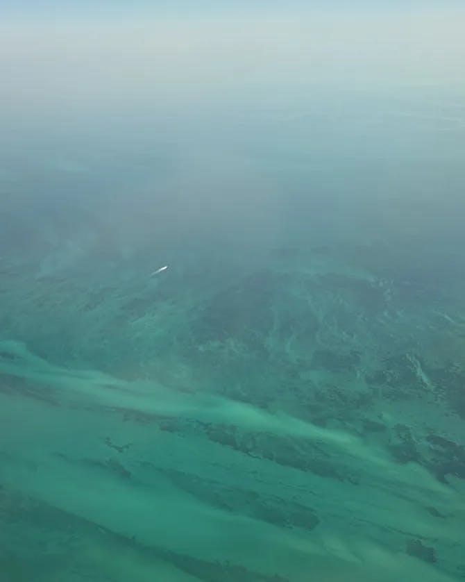 An aerial view of a turquoise blue water