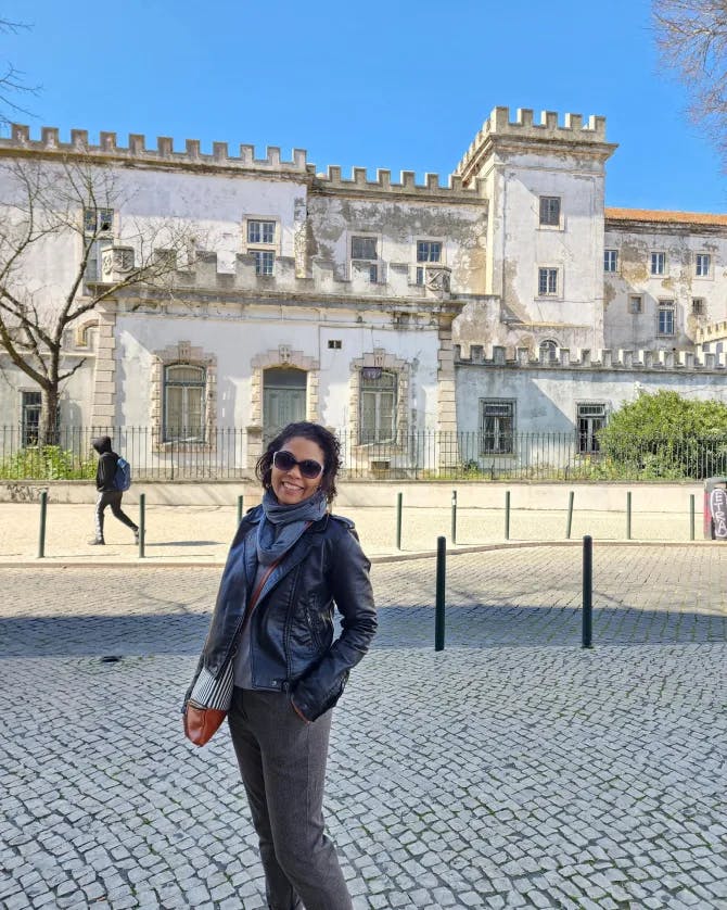 Picture of August at Quartel da Graça standing on a cobblestone road with a luxurious white building in the background