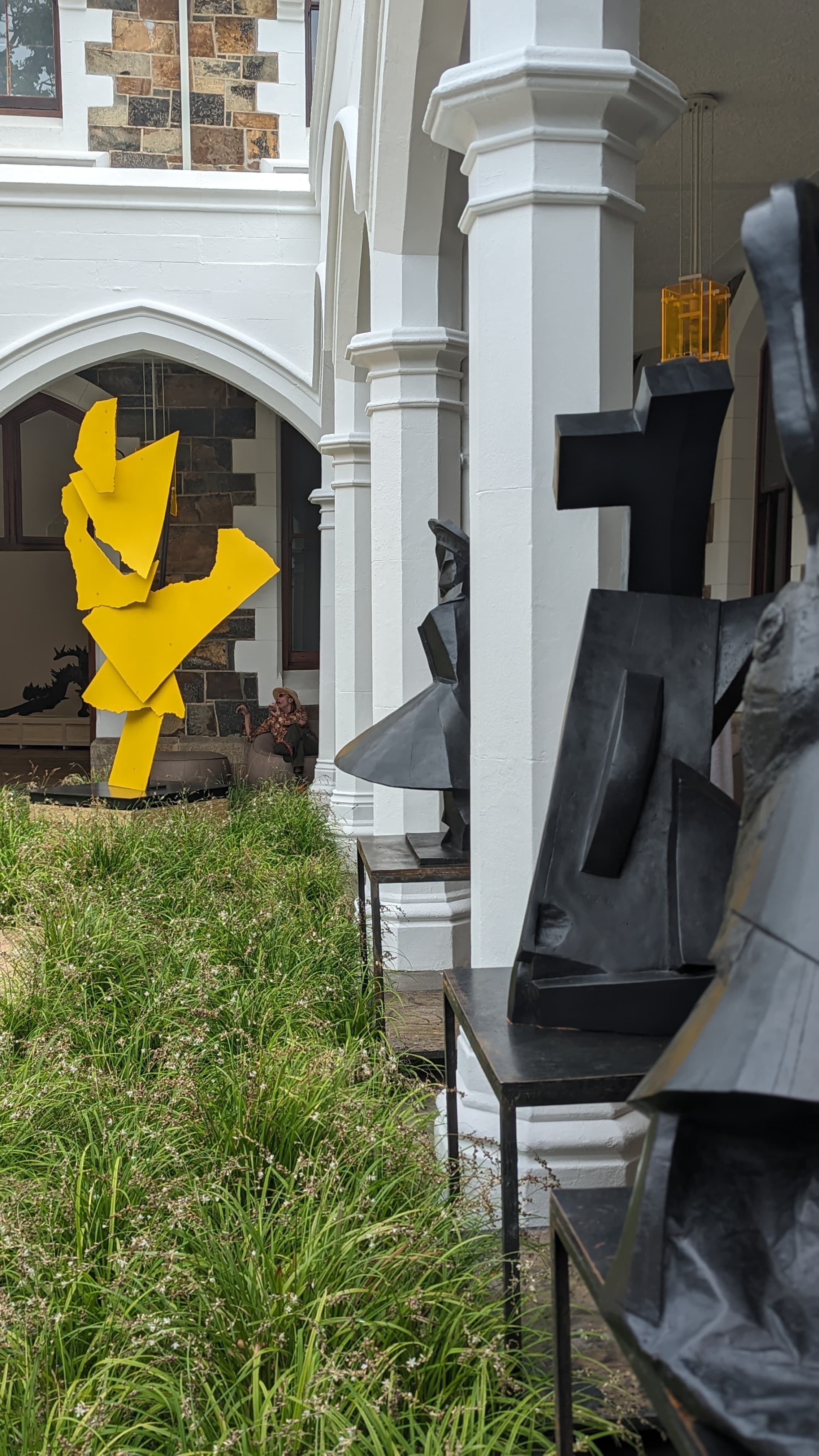 The white building with a garden in front