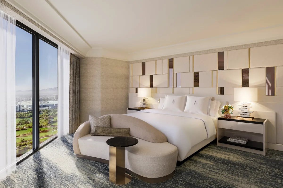 Elegant decor and furnishings fill a primary suite at Four Seasons Hotel Las Vegas with a great view of the city and nearby golf course