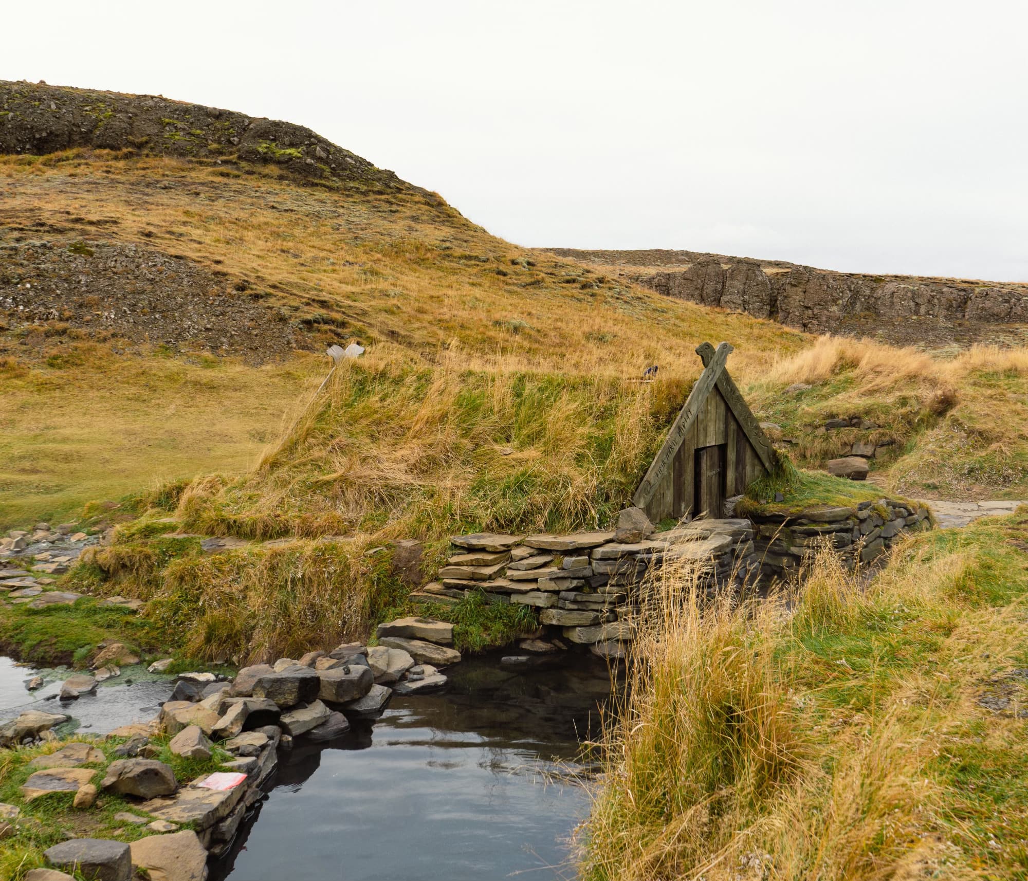 A beautiful picture of house along side a canal