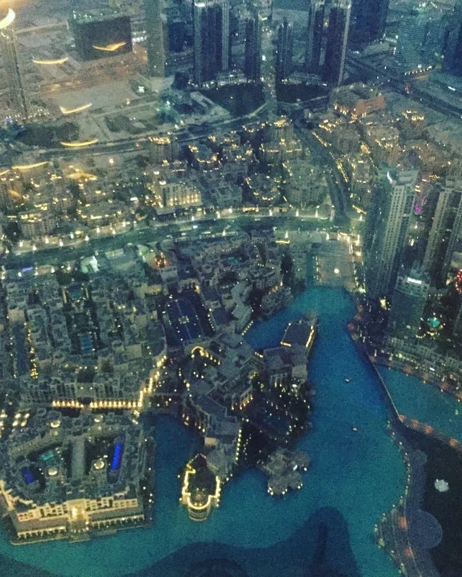 An aerial view of the city and harbor at nighttime 
