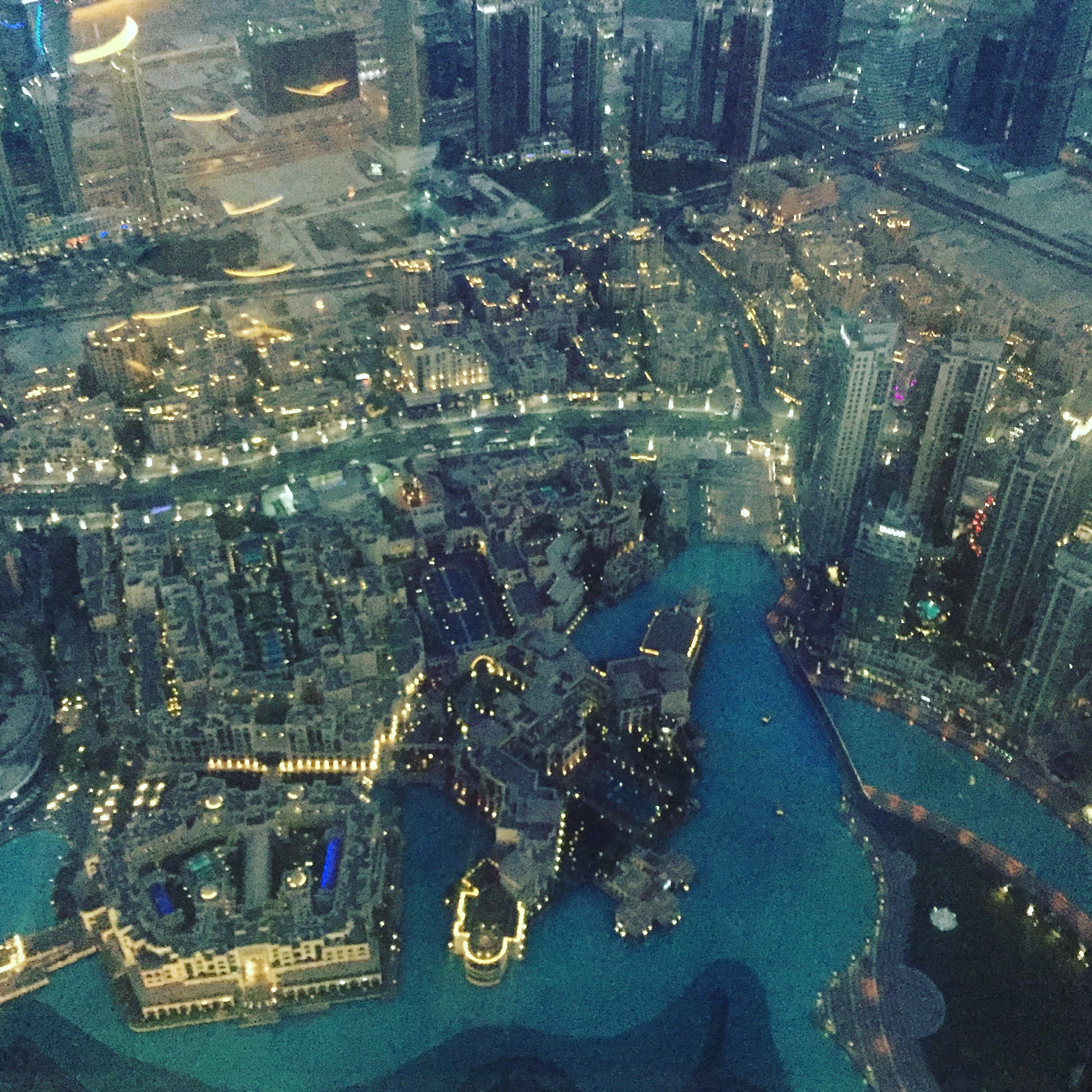 An aerial view of the city and harbor at nighttime