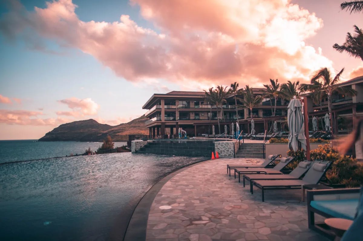 Prominently featured at dusk: an infinity pool at a luxury beach resort 