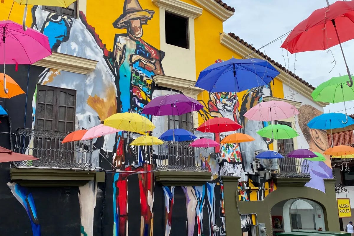 An outdoor setting with multi-colored umbrellas and walls