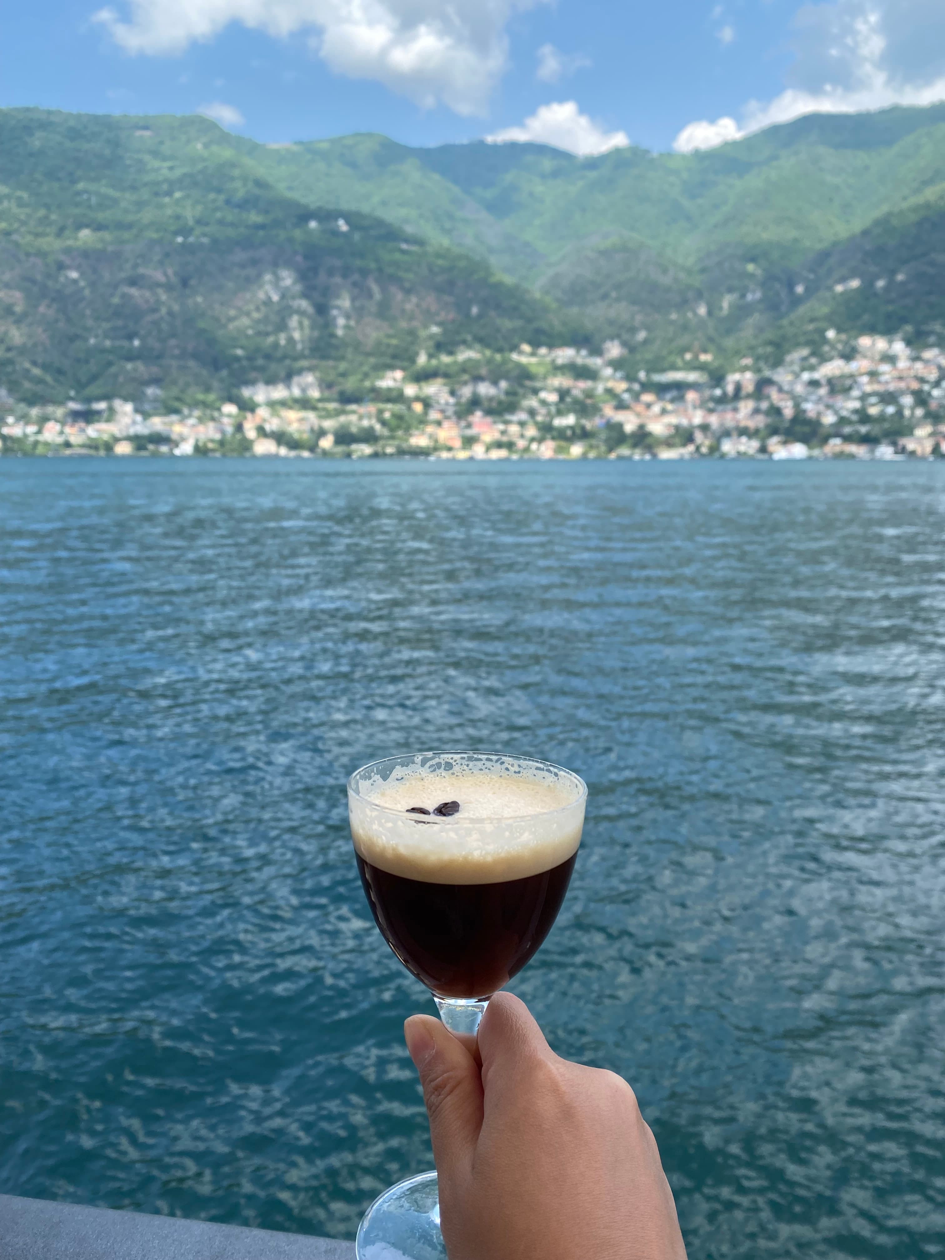 Picture of a glass in hand with sea view