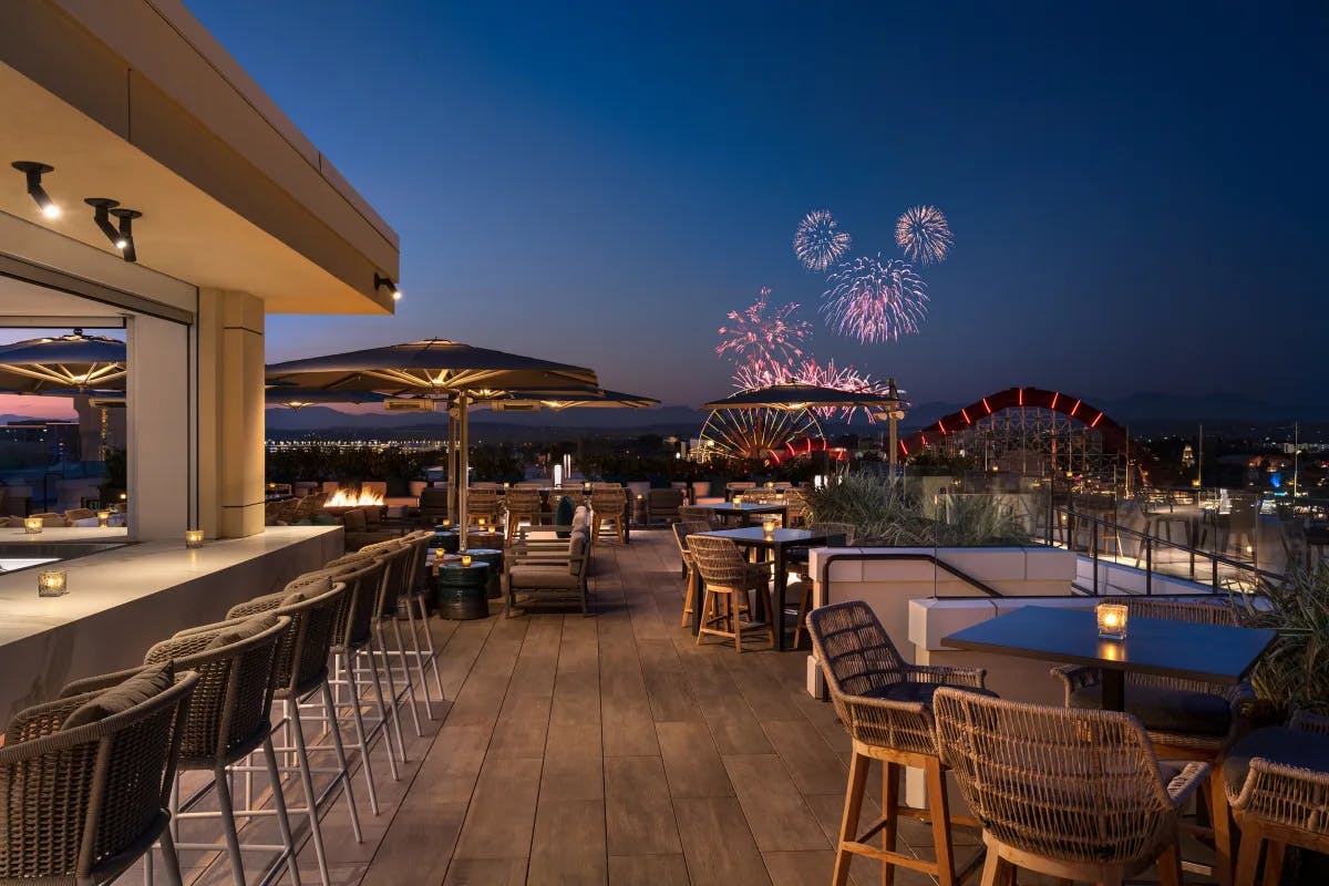 Enjoy your drink over Disneyland fireworks at RISE Rooftop.
