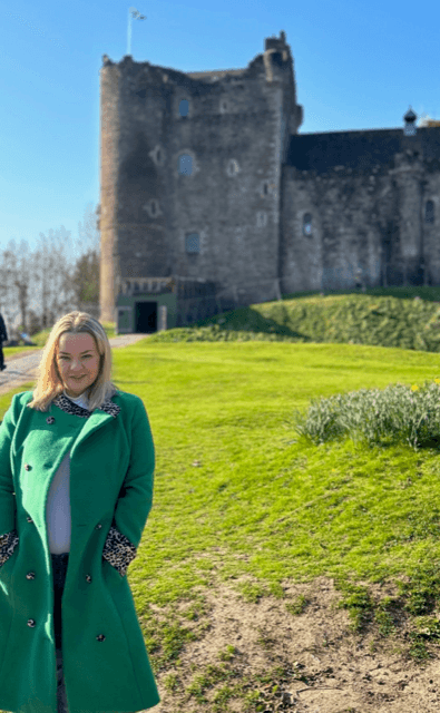 Travel advisor posing in green coat