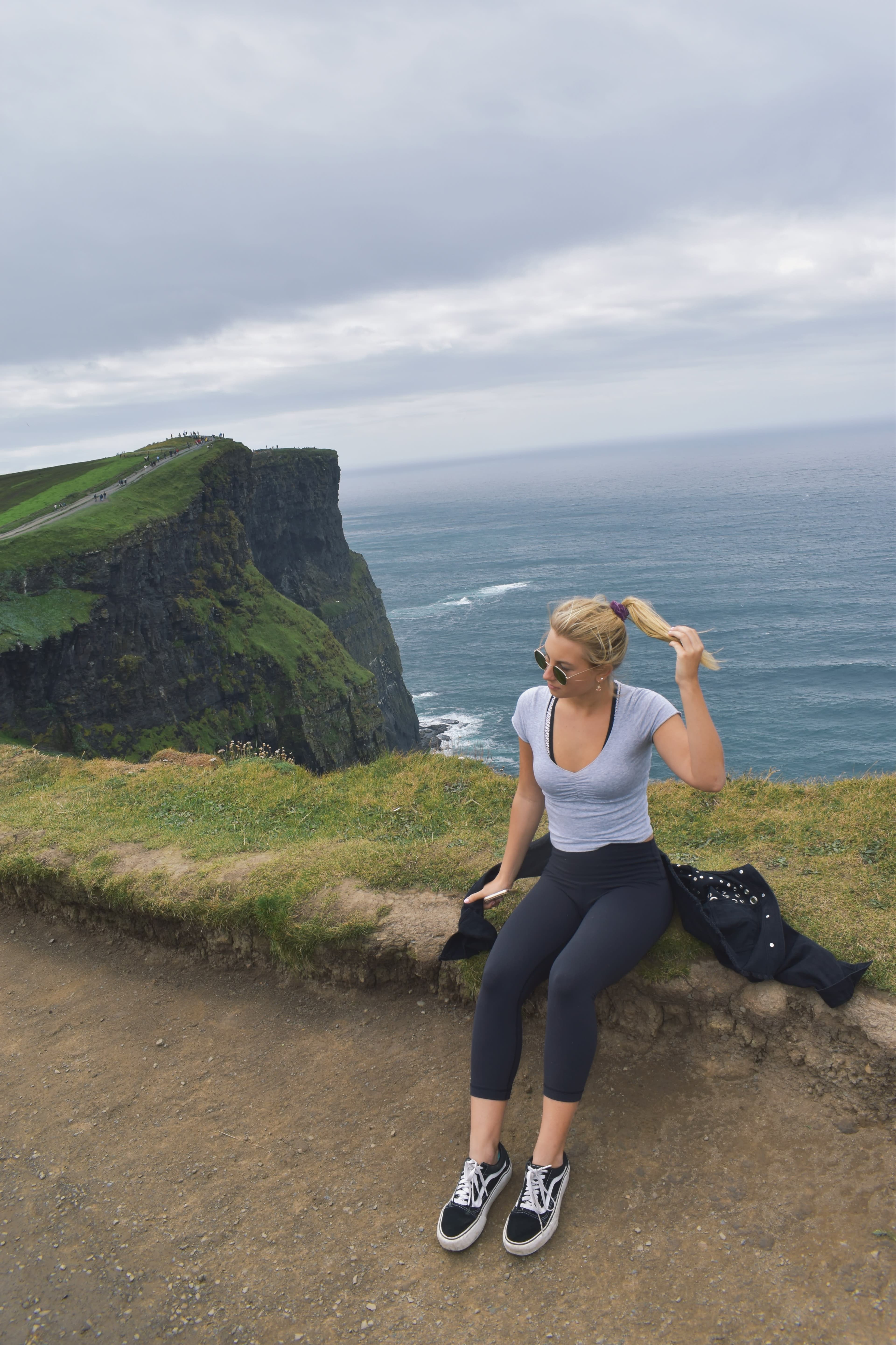 Posing for a photo on a trail by the sea