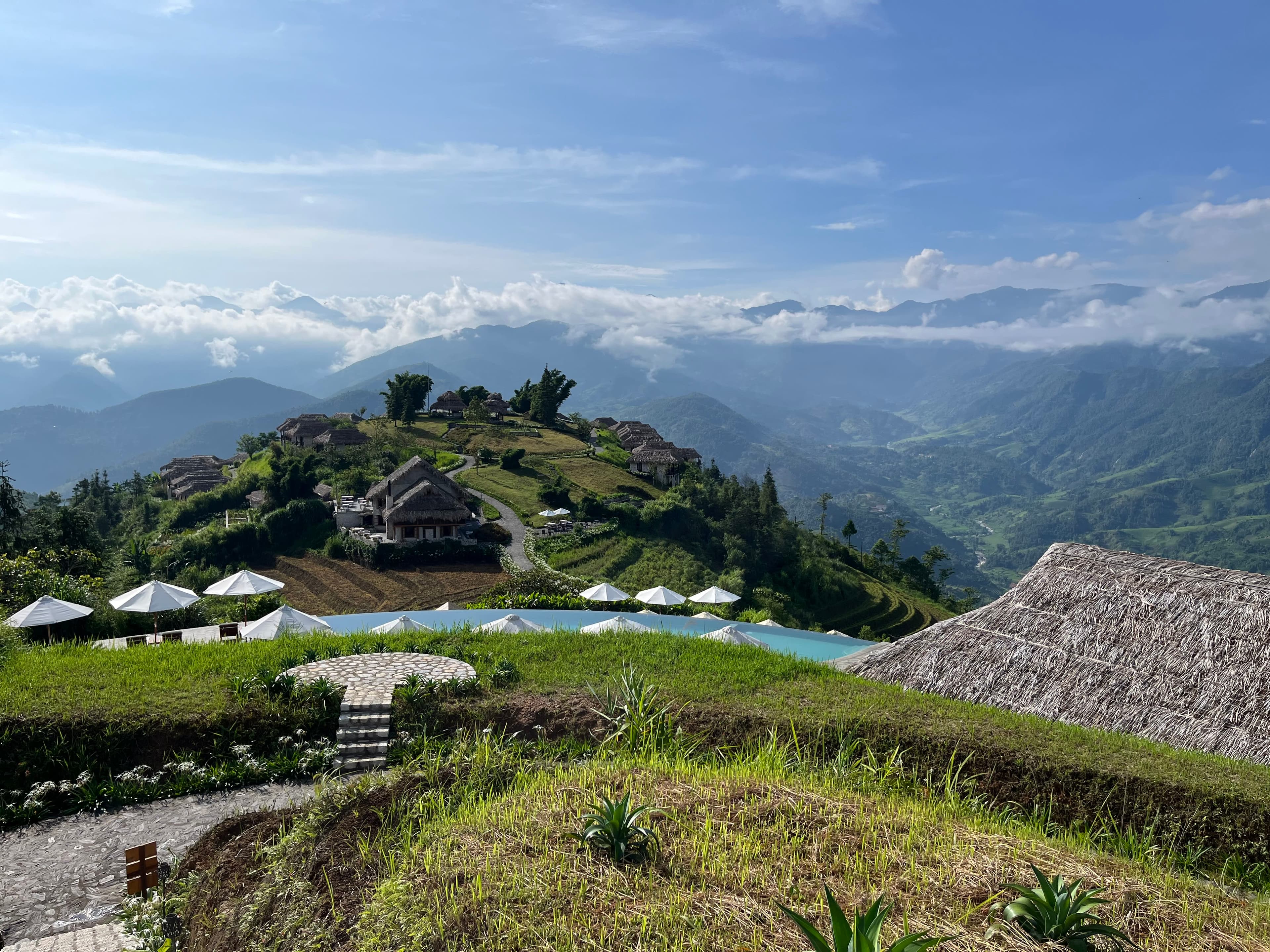 Picturesque view of a resort surrounded by green landscape and mountains