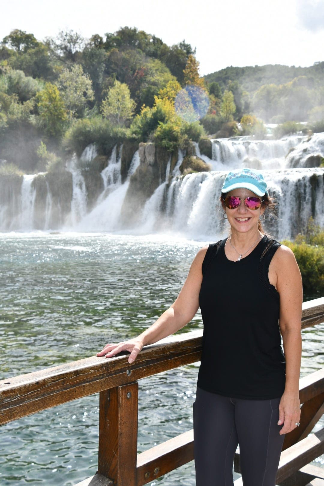 Posing for a photo by the waterfall