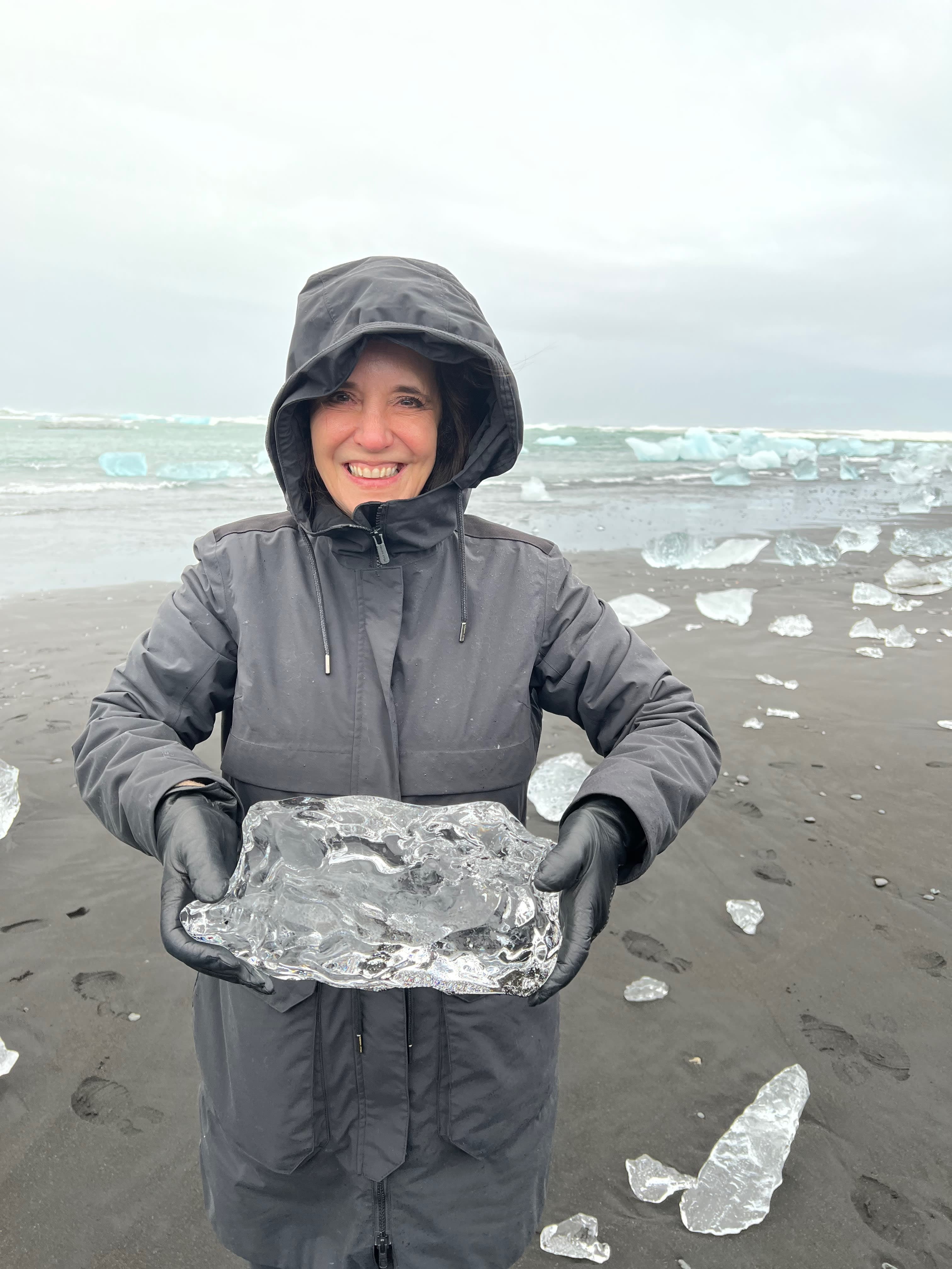 Holding a block of ice on the beach