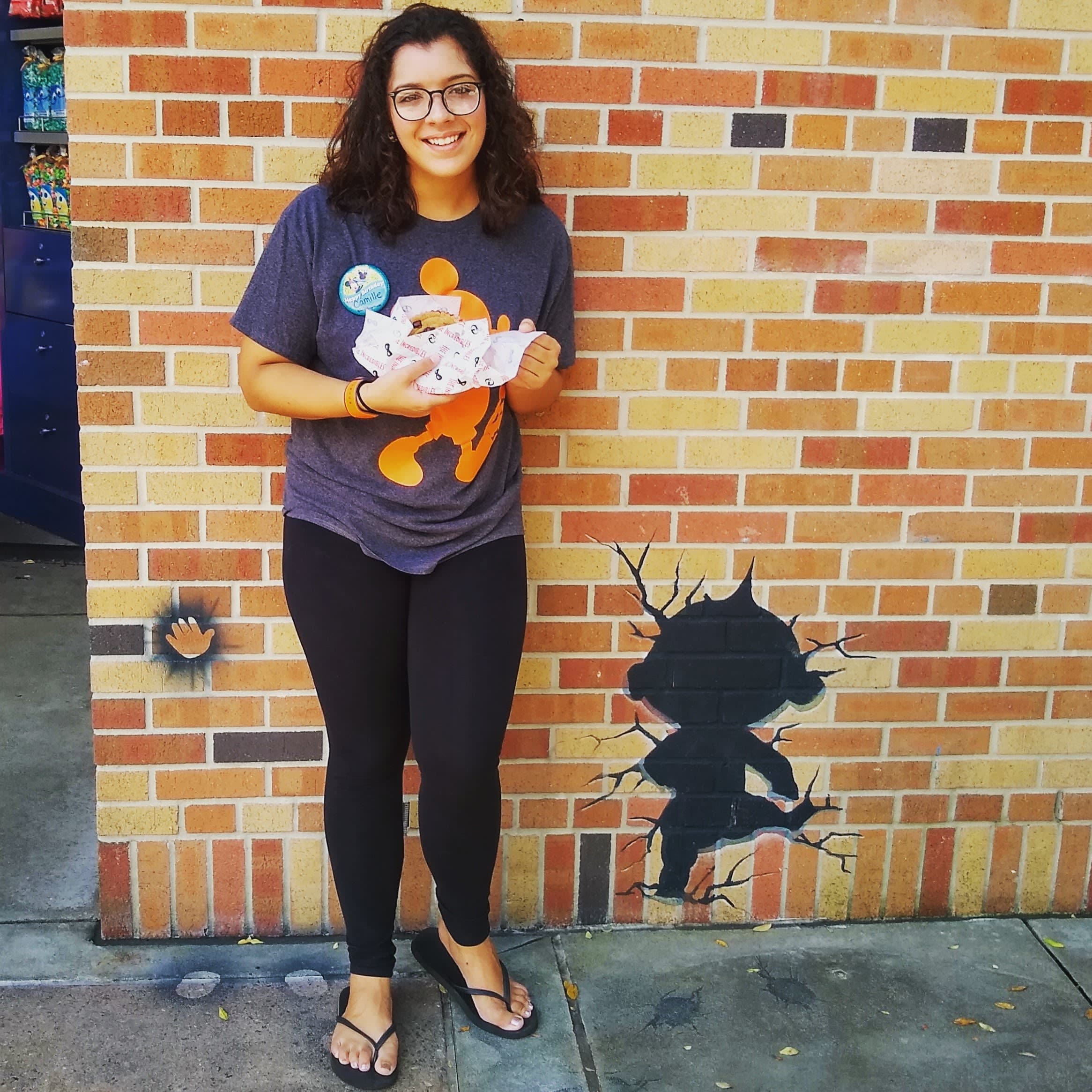 Camille posing for picture with food in hand