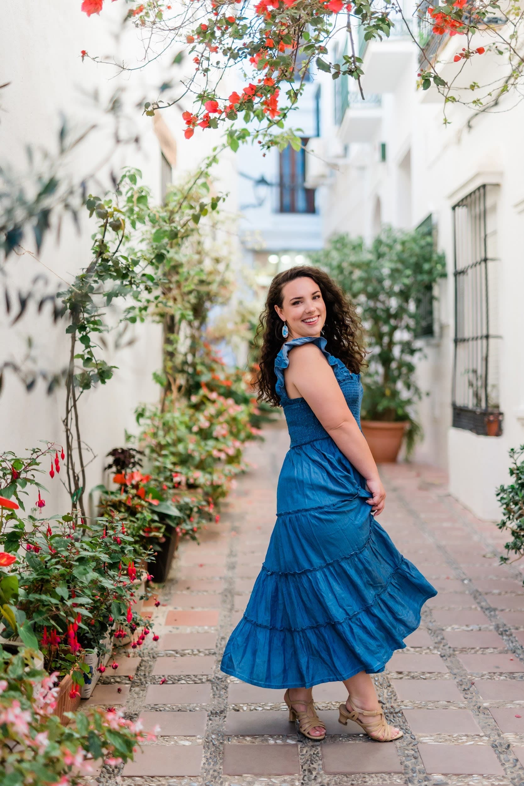 Posing for a photo in an alley filled with plants