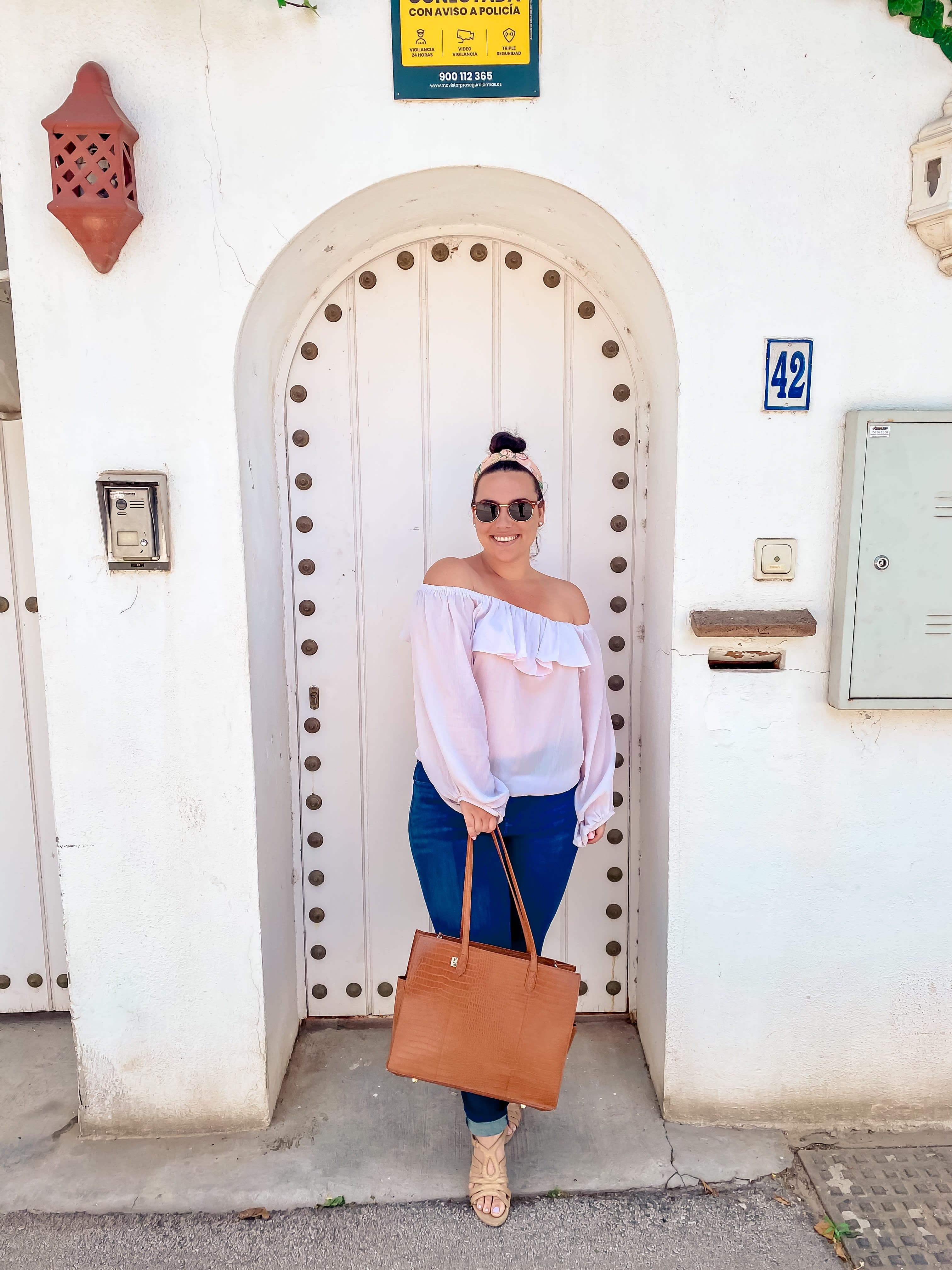 Posing for a photo standing outside the door of hotel room
