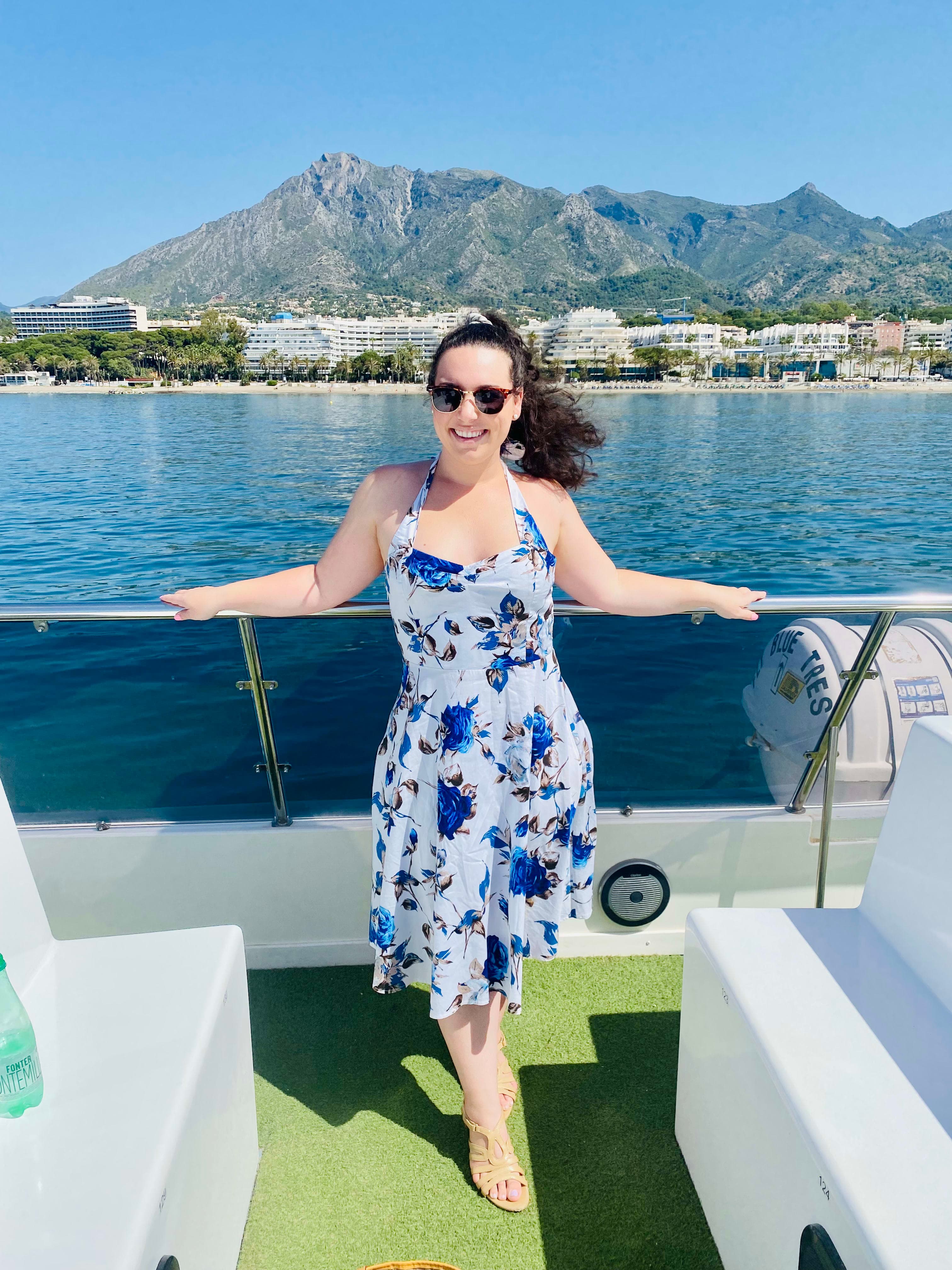 Posing for a photo in a floral dress on a boat