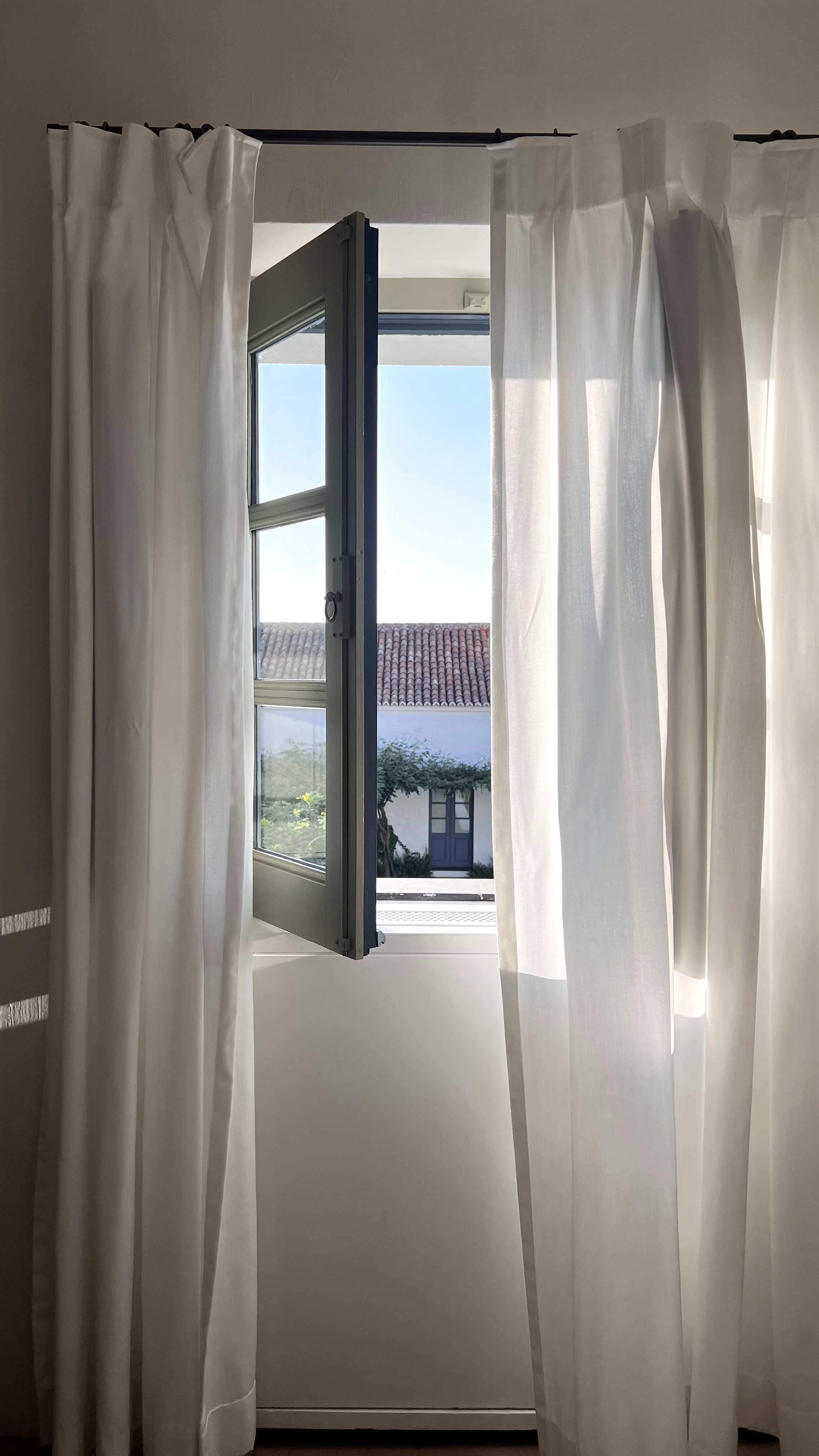View of a window with white curtains