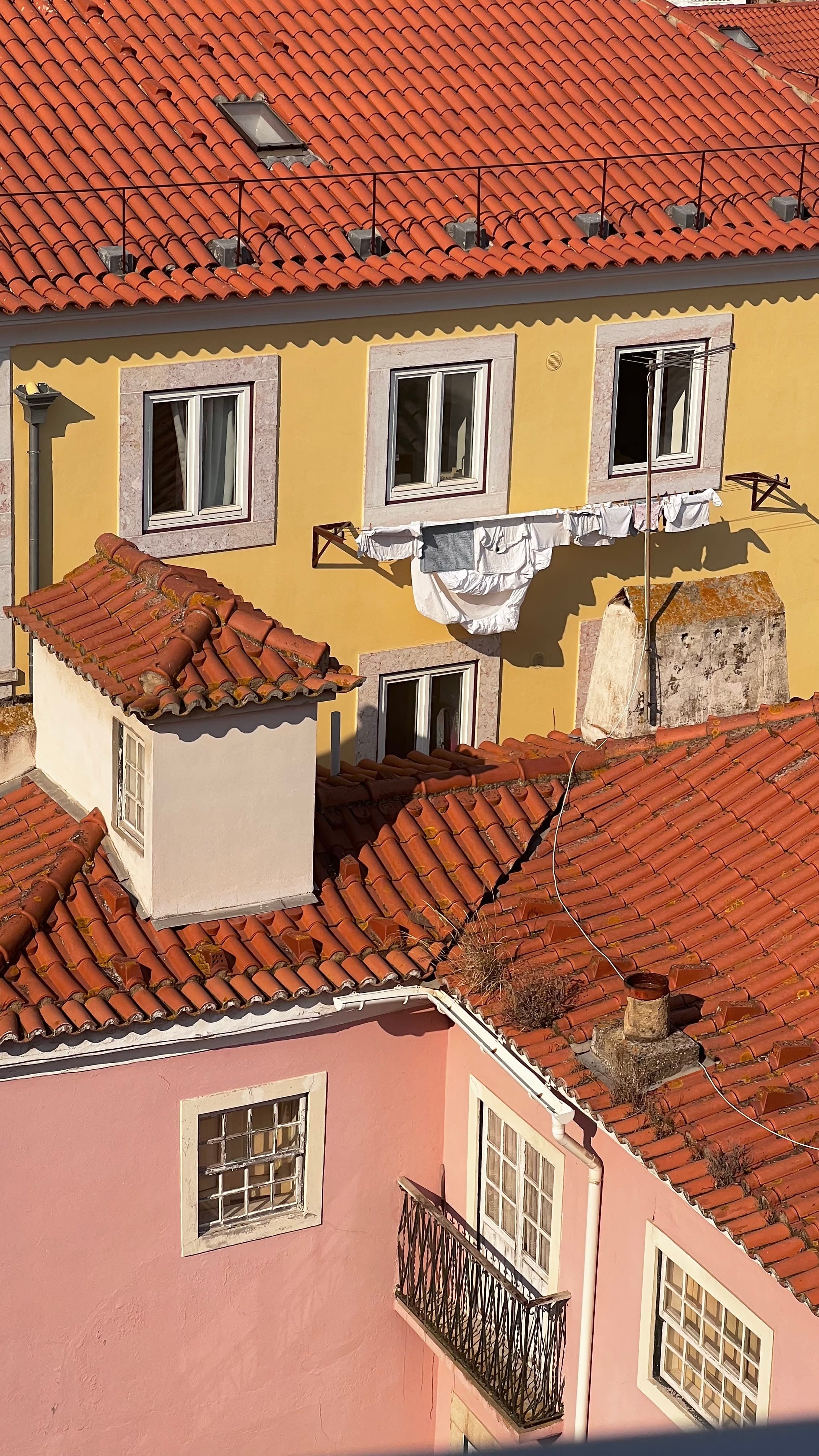 View of yellow and pink painted houses